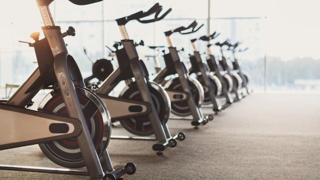 Modern gym interior with equipment, fitness exercise bikes 
