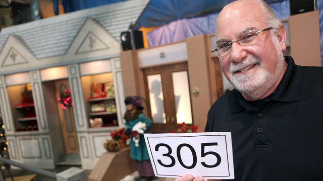 (061809 Boston, MA) Eliot Tatelman of Jordan's Furniture poses with part of the Enchanted Village after he made the winning auction bid, Thursday, June 18, 2009. Staff photo by Angela Rowlings 